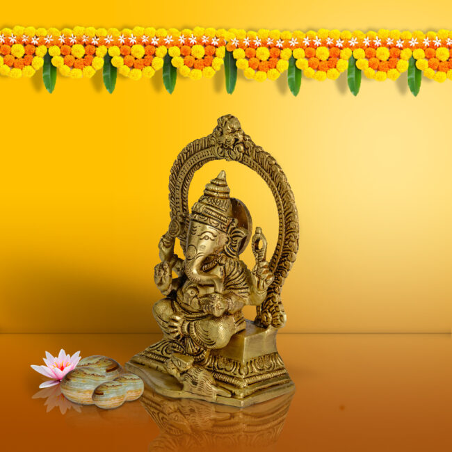 BRASS GANESHA - SEATED ON CARVED PEETHA WITH YALLI CARVED ARCH
